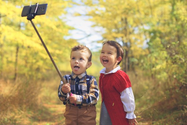 two little kids taking selfie